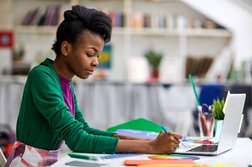 JAMB-Young-lady-in-green-studying-in-a-library